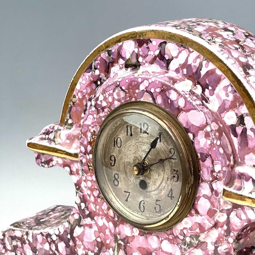 845 - A French pink lustre three-piece clock set, circa 1920, with mottled splash decoration, with two cla... 