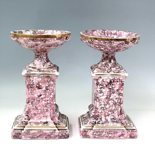 845 - A French pink lustre three-piece clock set, circa 1920, with mottled splash decoration, with two cla... 
