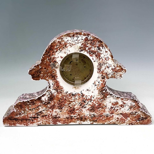 845 - A French pink lustre three-piece clock set, circa 1920, with mottled splash decoration, with two cla... 