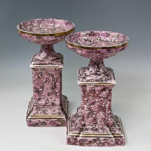845 - A French pink lustre three-piece clock set, circa 1920, with mottled splash decoration, with two cla... 