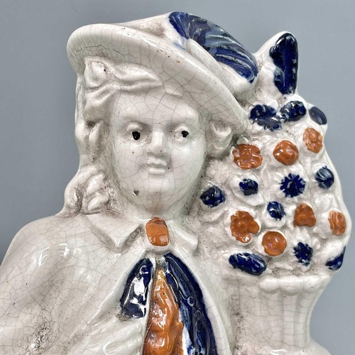 883 - A pair of Victorian Staffordshire flatback figures, of a young man and his companion, each beside a ... 