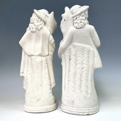 883 - A pair of Victorian Staffordshire flatback figures, of a young man and his companion, each beside a ... 