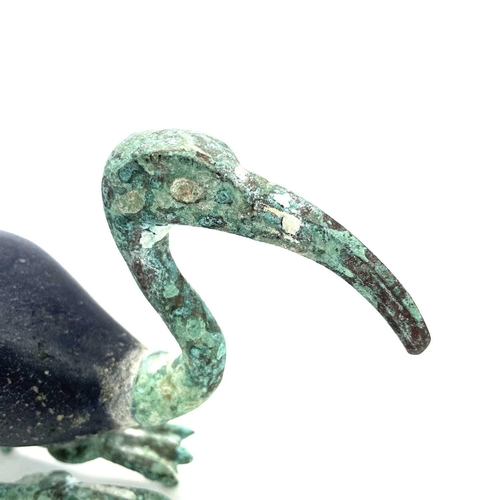 10 - Egyptian style, after the Ptolemaic period A bronze and glass figure of a resting ibis, height 13.5c... 