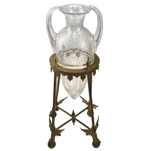 102 - A Victorian etched glass amphora shape vase, with twin handles, contained in a gilt brass stand with... 