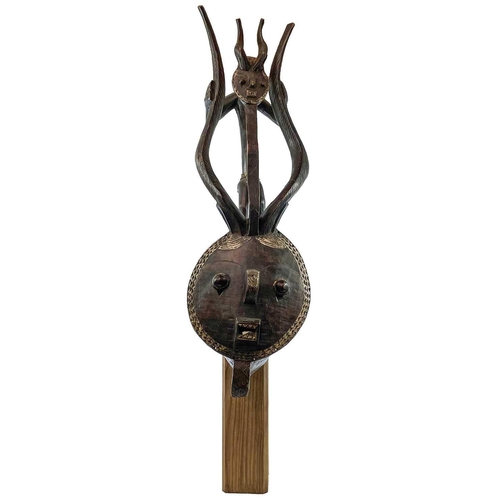 107 - A Kple-Kple Goli Mask, with elaborate horns, and surmounted by a further horned figure, Baale, Ivory... 