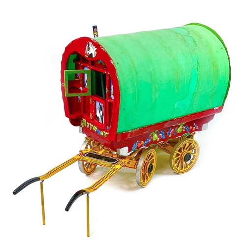 108 - A wooden model of a Romany Gypsy caravan, with fitted interior, the exterior painted with piebald ho... 