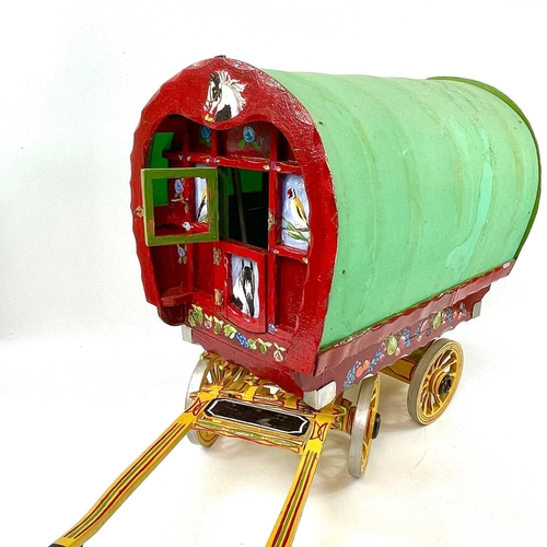 108 - A wooden model of a Romany Gypsy caravan, with fitted interior, the exterior painted with piebald ho... 