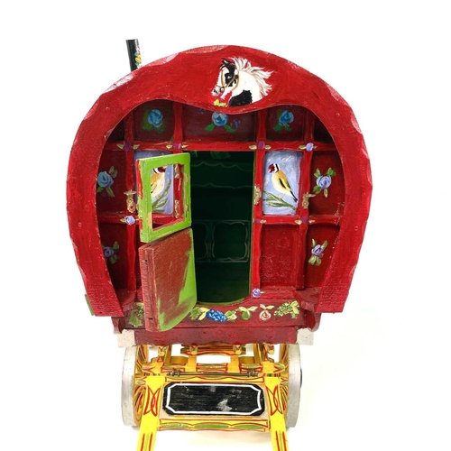 108 - A wooden model of a Romany Gypsy caravan, with fitted interior, the exterior painted with piebald ho... 