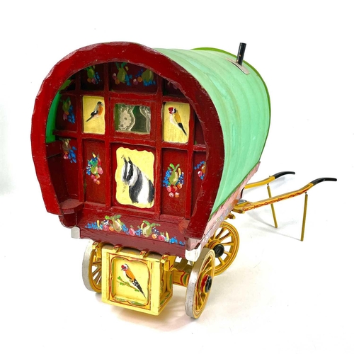 108 - A wooden model of a Romany Gypsy caravan, with fitted interior, the exterior painted with piebald ho... 