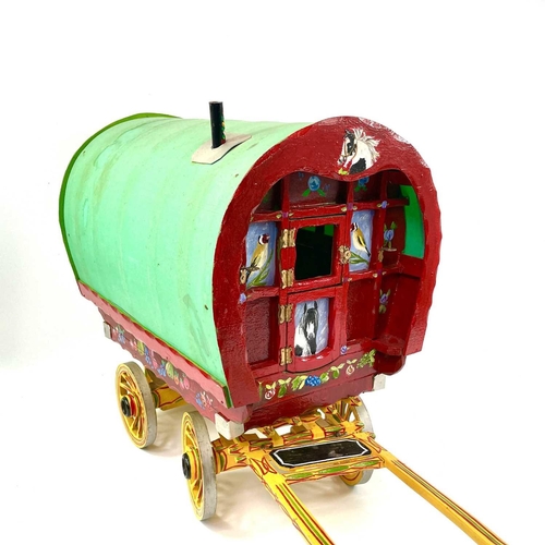 108 - A wooden model of a Romany Gypsy caravan, with fitted interior, the exterior painted with piebald ho... 