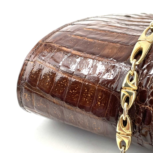 109 - A 1930s/1940s two tone crocodile skin handbag with gilt metal strap. Width 27.5cm.