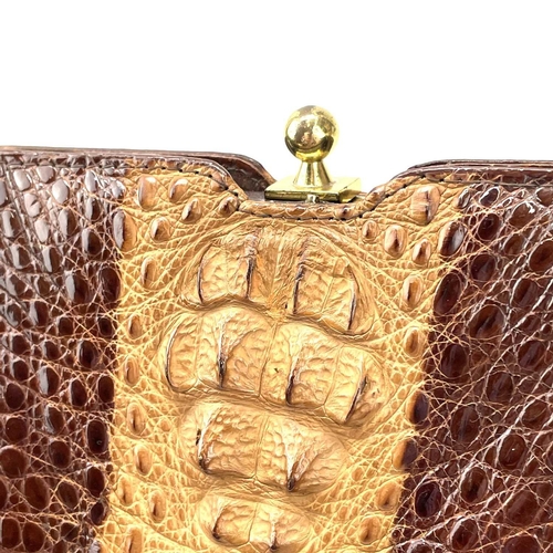 109 - A 1930s/1940s two tone crocodile skin handbag with gilt metal strap. Width 27.5cm.