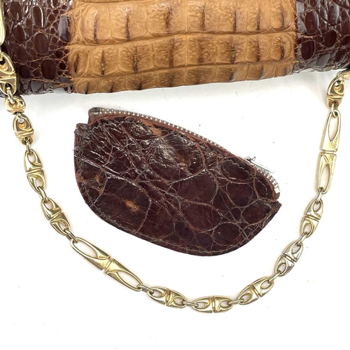 109 - A 1930s/1940s two tone crocodile skin handbag with gilt metal strap. Width 27.5cm.