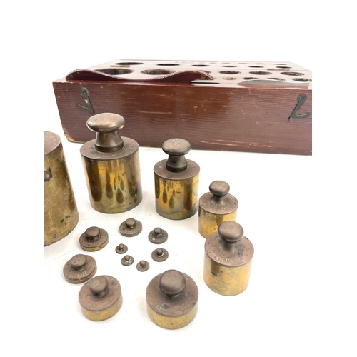 111 - A cased set of metric brass weights, the box labelled BTL, ranging from 1gram to 2Kg, with lifter an... 