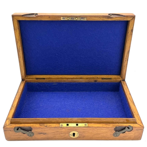 126 - An oak box, 19th century, probably for a pistol, with central brass boss, catches and screws, gutted... 