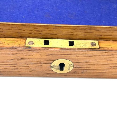 126 - An oak box, 19th century, probably for a pistol, with central brass boss, catches and screws, gutted... 