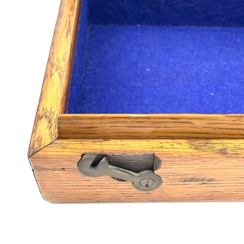 126 - An oak box, 19th century, probably for a pistol, with central brass boss, catches and screws, gutted... 