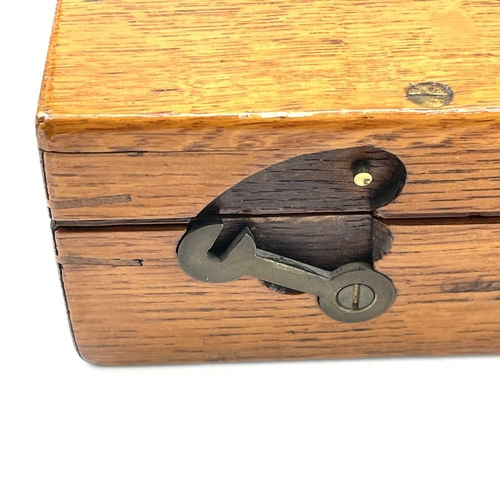 126 - An oak box, 19th century, probably for a pistol, with central brass boss, catches and screws, gutted... 