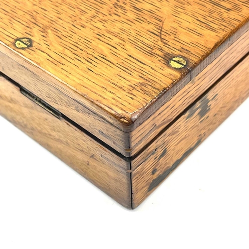 126 - An oak box, 19th century, probably for a pistol, with central brass boss, catches and screws, gutted... 