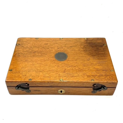 126 - An oak box, 19th century, probably for a pistol, with central brass boss, catches and screws, gutted... 