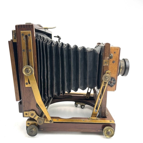 151 - A W.Butcher & Sons National Camera, 1/4 plate folding camera together with a plate negative of a fam... 