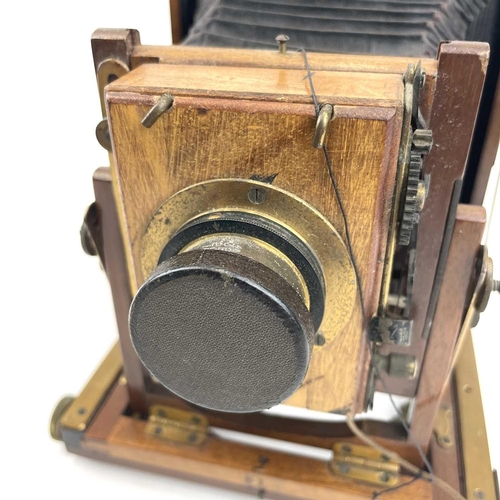 151 - A W.Butcher & Sons National Camera, 1/4 plate folding camera together with a plate negative of a fam... 