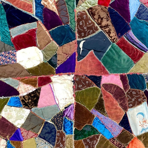 1601 - A Victorian patchwork quilt with various velvet sections 180cm x 144cm together with a Victorian pri... 