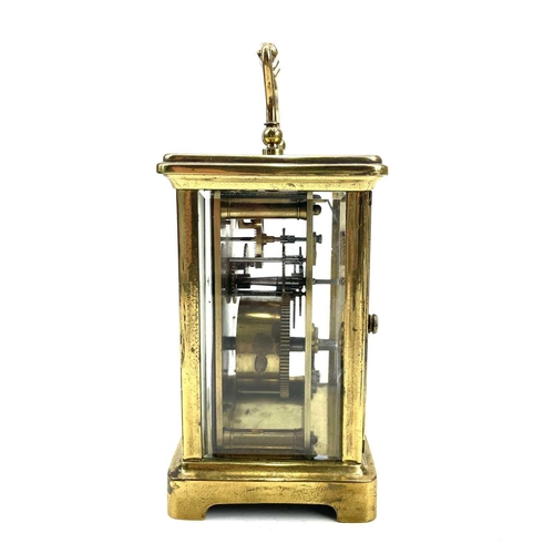 1708 - A French brass carriage clock with Roman numeral dial on a white enamelled face and original carry c... 