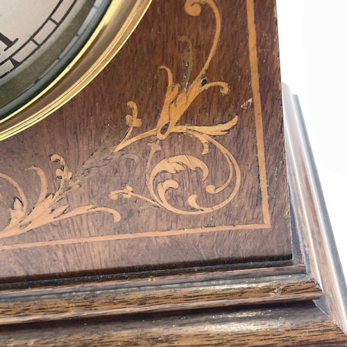 1713 - A mahogany and inlaid lancet shape mantel clock, circa 1900, with silvered dial, striking on two gon... 