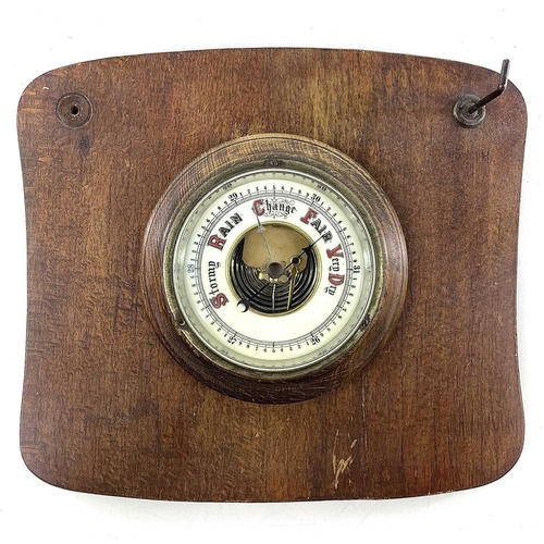 1714 - A brass marine aneroid barometer, the silvered dial stamped F.Smith & Son, Southampton, on an oak mo... 