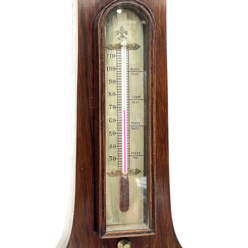 1718 - A Victorian rosewood wheel barometer, with silvered dial and incorporating a thermometer, convex mir... 