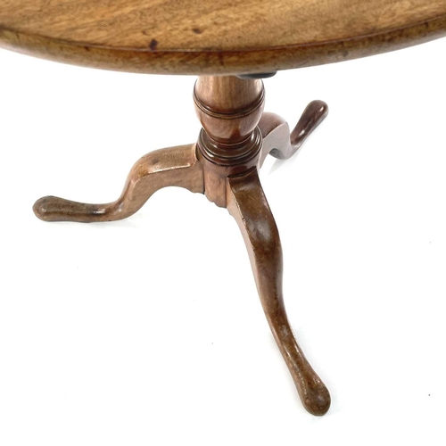 1807 - A walnut circular tripod table, 19th century, with a tilt top and turned pillar, height 67cm, diamet... 