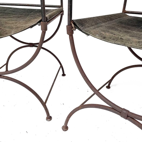 1813 - A pair of wrought Iron 'Bishop's' chairs, mid 20th century, with suede leather backs and slung seats... 