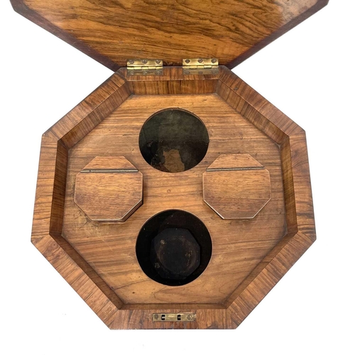 1820 - A Victorian walnut octagonal teapoy, the hinged top revealing two lidded containers and recesses for... 