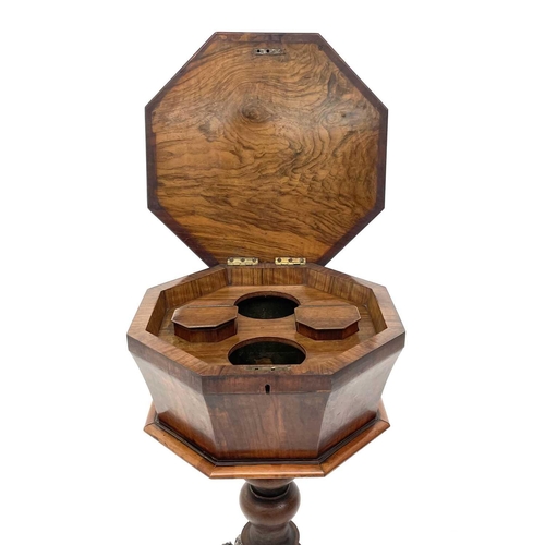 1820 - A Victorian walnut octagonal teapoy, the hinged top revealing two lidded containers and recesses for... 