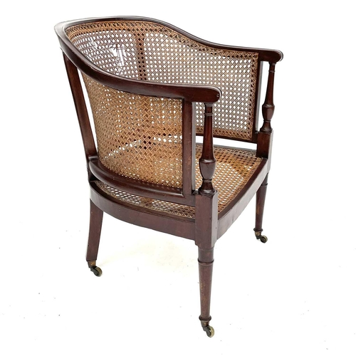 1827 - A Regency mahogany Bergere armchair, with rattan back and seat, on turned tapering front legs, heigh... 