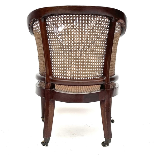 1827 - A Regency mahogany Bergere armchair, with rattan back and seat, on turned tapering front legs, heigh... 