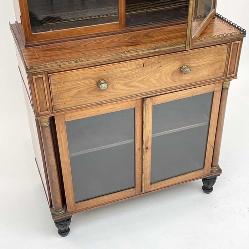 1828 - A Regency rosewood and kingwood banded secretaire cabinet, the upper part with two glazed doors with... 