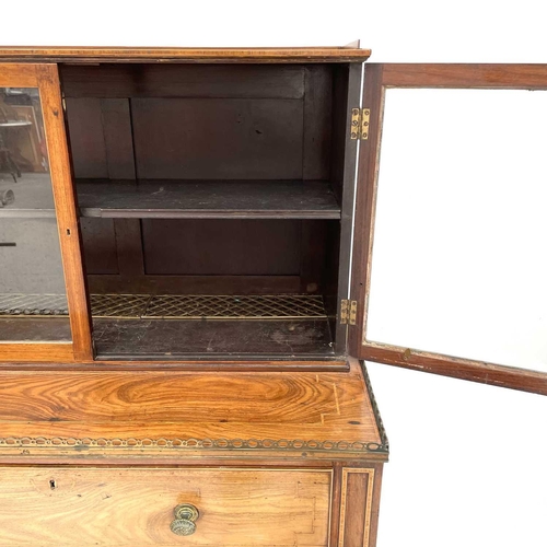 1828 - A Regency rosewood and kingwood banded secretaire cabinet, the upper part with two glazed doors with... 