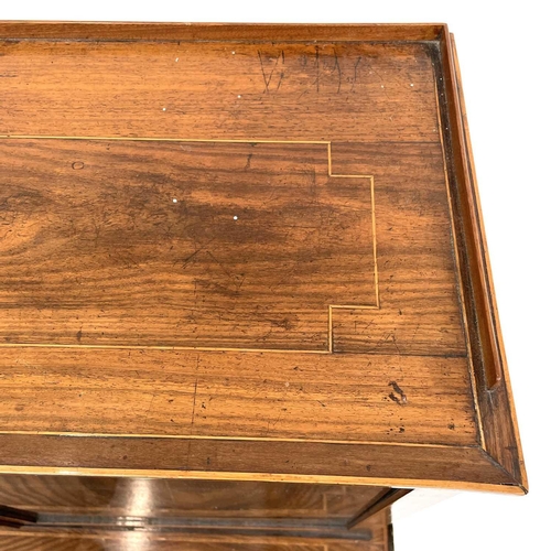 1828 - A Regency rosewood and kingwood banded secretaire cabinet, the upper part with two glazed doors with... 