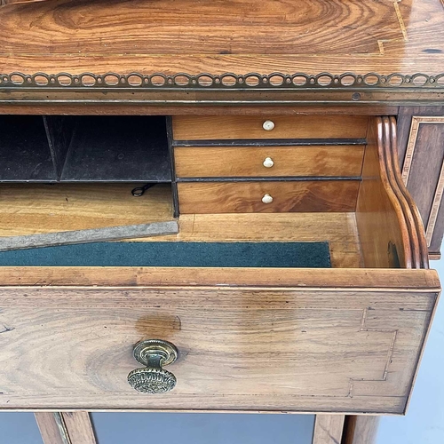 1828 - A Regency rosewood and kingwood banded secretaire cabinet, the upper part with two glazed doors with... 