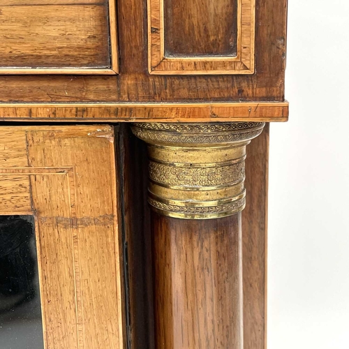 1828 - A Regency rosewood and kingwood banded secretaire cabinet, the upper part with two glazed doors with... 