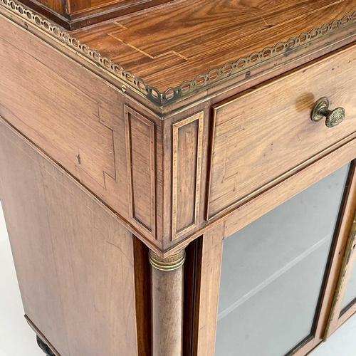 1828 - A Regency rosewood and kingwood banded secretaire cabinet, the upper part with two glazed doors with... 