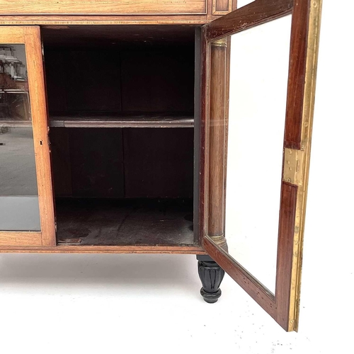 1828 - A Regency rosewood and kingwood banded secretaire cabinet, the upper part with two glazed doors with... 