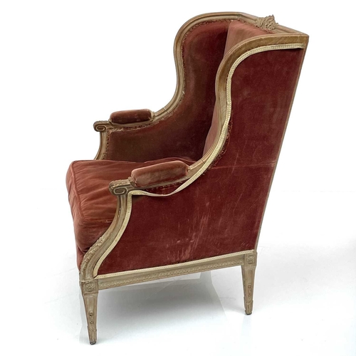 1831 - A French Loius XV style beech wing armchair, circa 1900, with leaf carved decoration and lappet arm ... 