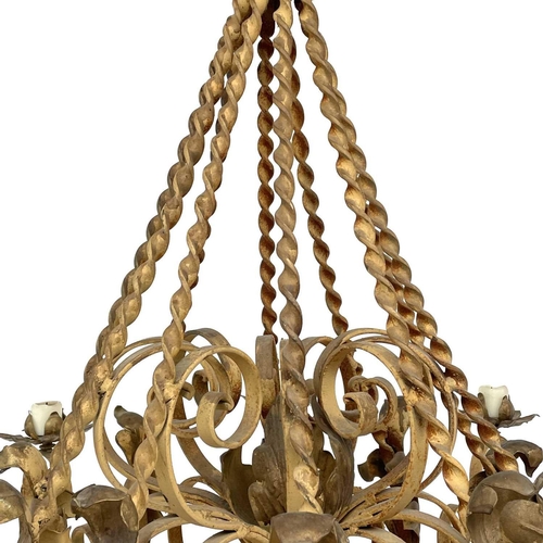 1852 - A substantial Continental yellow and gilt painted wrought iron chandelier, with twist and foliate ap... 