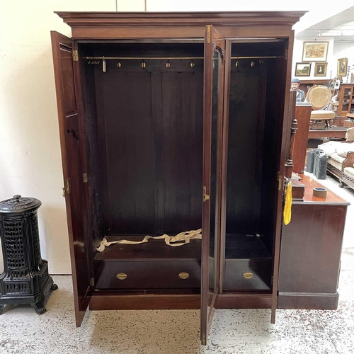 1858 - A late Victorian walnut triple wardrobe, with floral carved and mirrored panels enclosing hanging sp... 