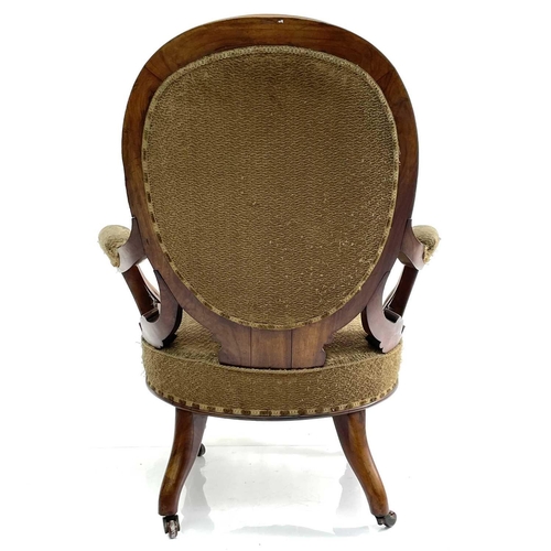 1859 - A Victorian walnut spoon back armchair, with padded back, arms, and seat and with carved and scroll ... 