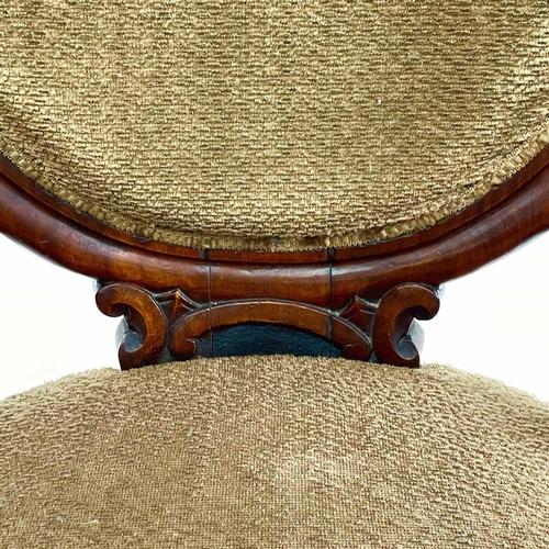 1859 - A Victorian walnut spoon back armchair, with padded back, arms, and seat and with carved and scroll ... 