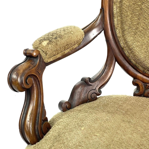 1859 - A Victorian walnut spoon back armchair, with padded back, arms, and seat and with carved and scroll ... 